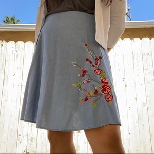 blue skirt with red flower embroidery